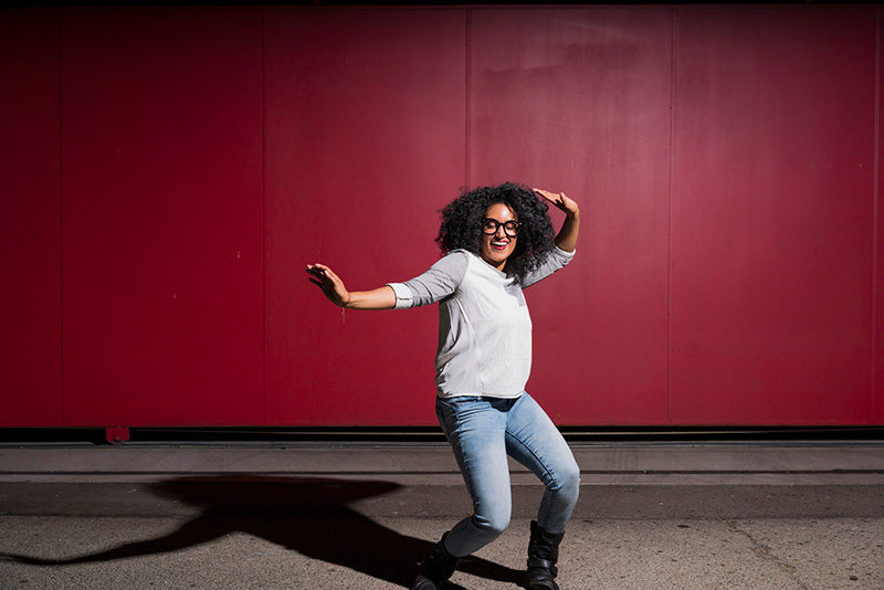 happy woman dancing on red background