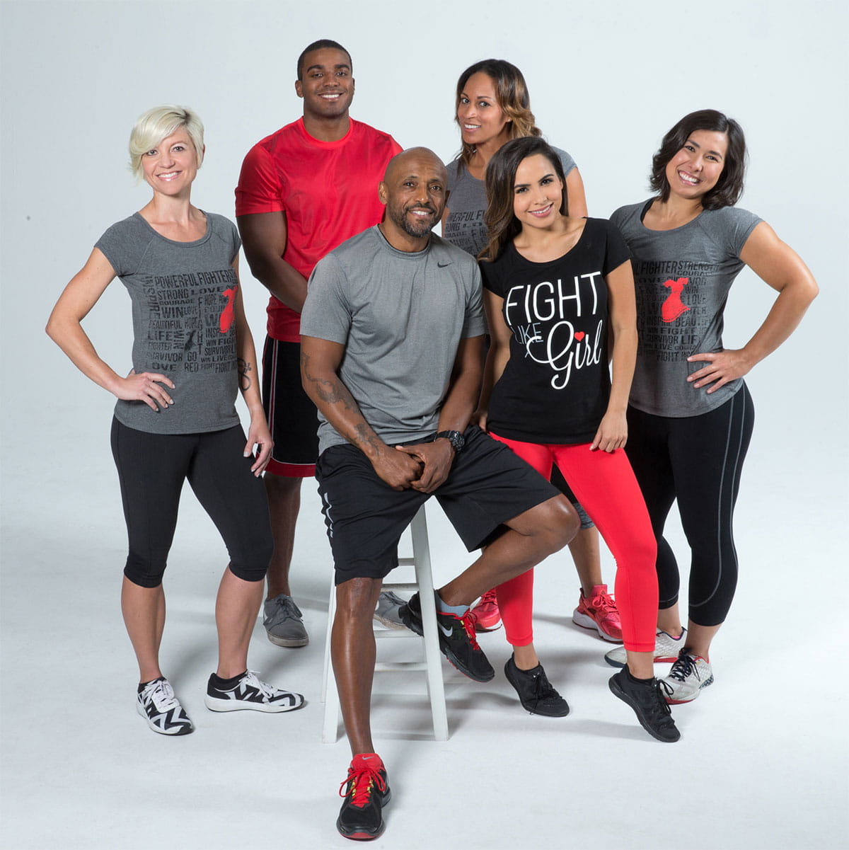 Group portrait of diverse adults in athletic attire