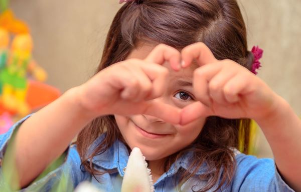 young girl showing love