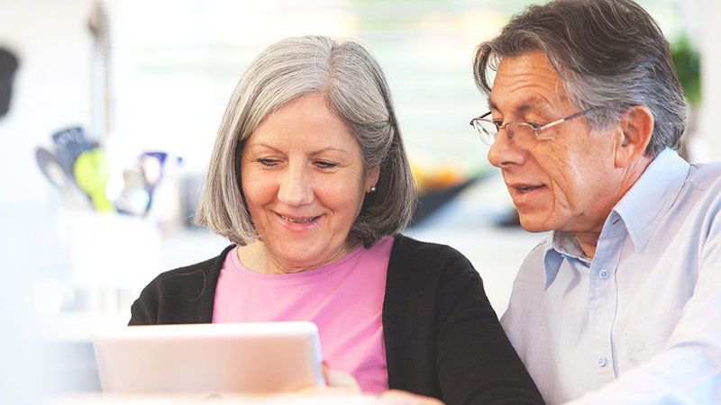 couple looking at a tablet screen