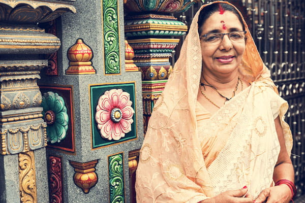 Senior South Asian Indian woman smiling at a temple