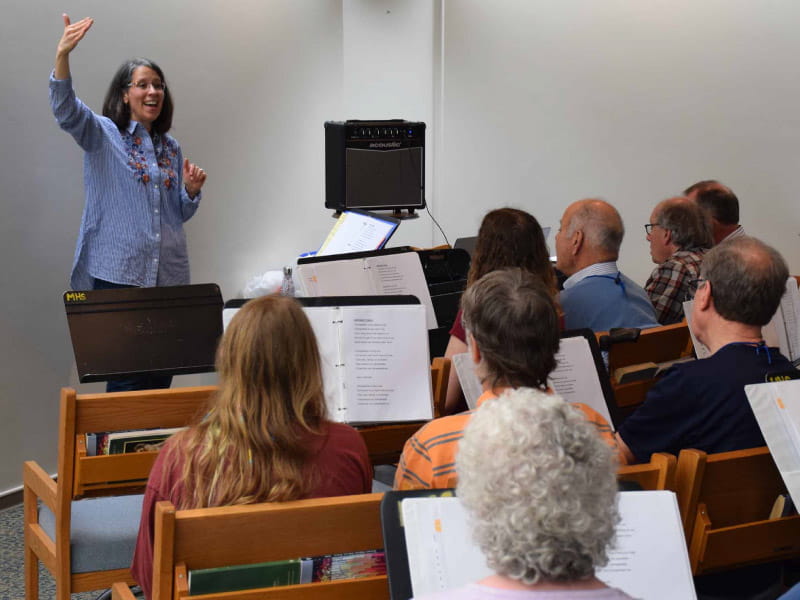 Karen McFeeters Leary, the speech pathologist who founded the Aphasia Choir of Vermont, directs choir rehearsal. (Photo courtesy of Karen McFeeters Leary)