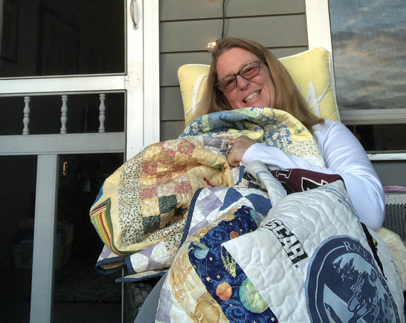 Liz Hindinger with the quilt her aunt made using fabrics donated by family and friends during Liz's recovery.(Photo courtesy of Elizabeth Hindinger) 
