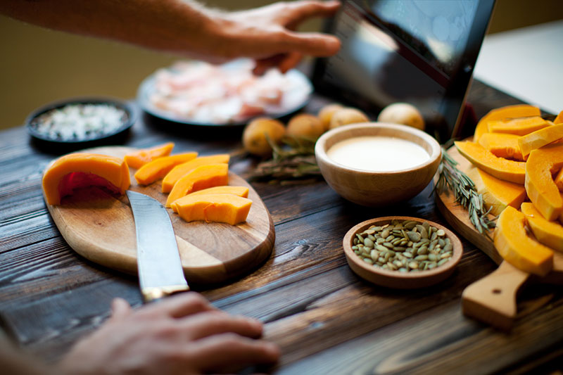 man cooking Fall foods using table for recipe man cooking Fall foods using table for recipe