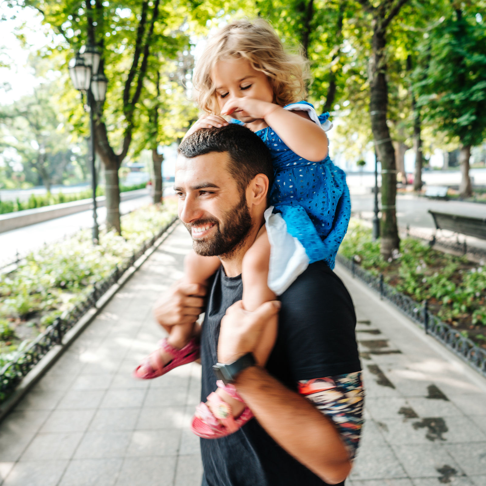 little-girl-riding-on-dads-neck-RF7WCGN