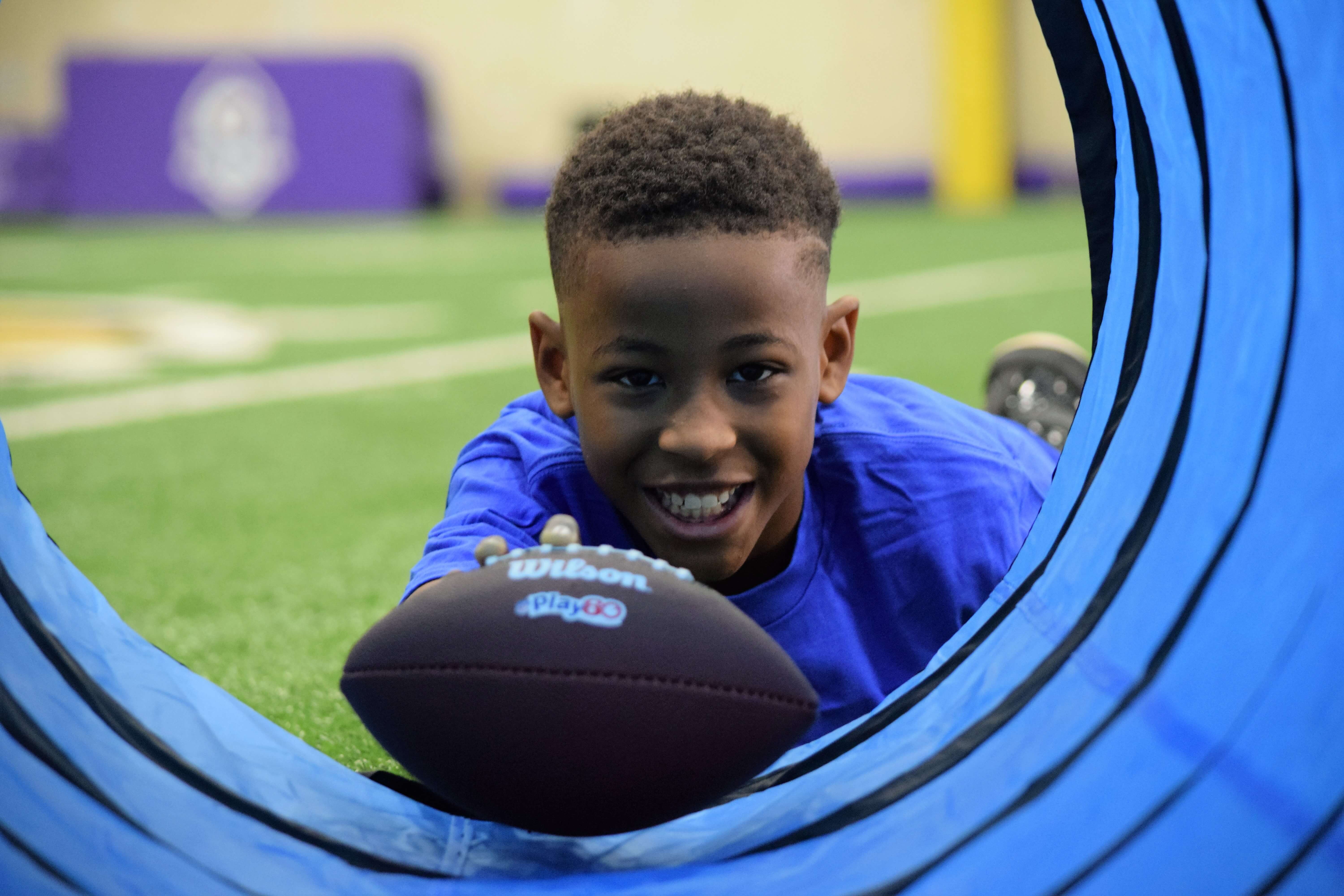 Boy with football in tunnel